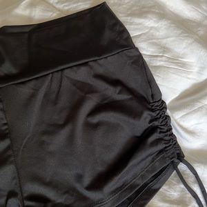Forever 21 black shorts with cinch ties on sides of legs. Size L. NWT